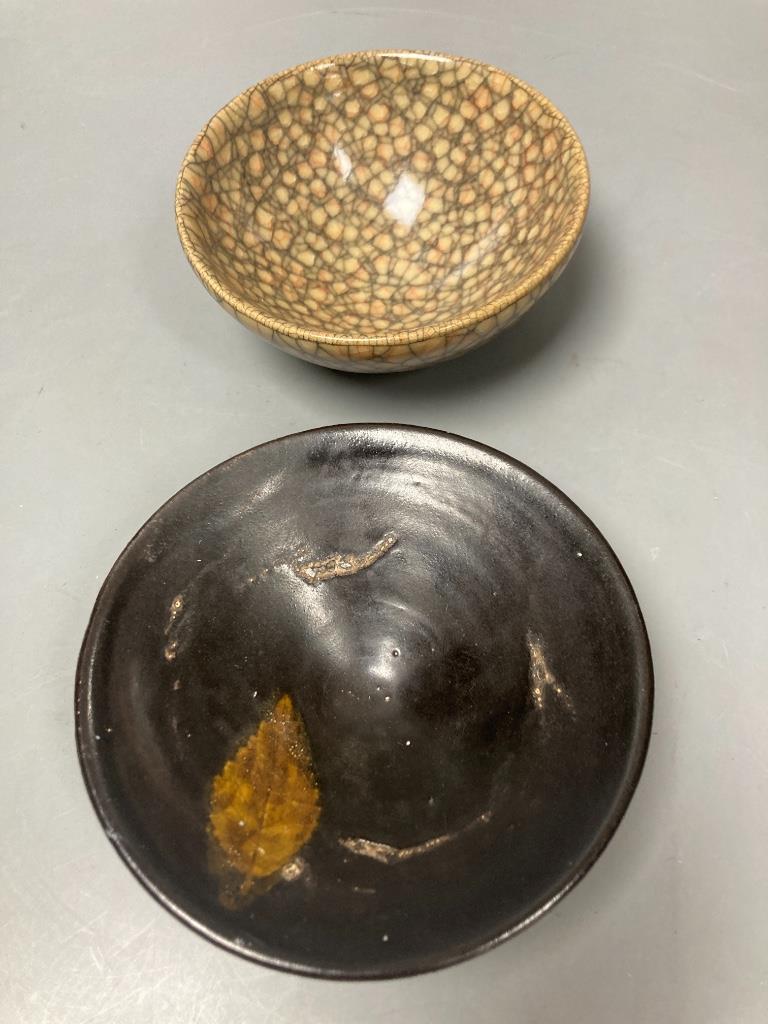 A Jian type crackle glaze bowl, diameter 10cm, and another Jian type bowl with one leaf